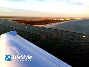 DA40 Flying over beach at sunset